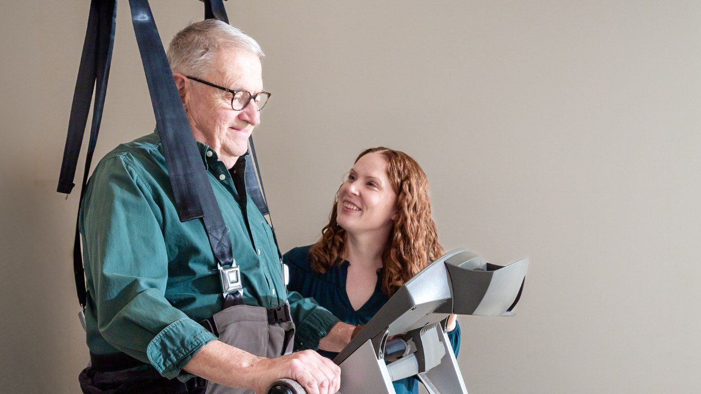 A South Valley physical therapist working with a patient in a body-weight support harness