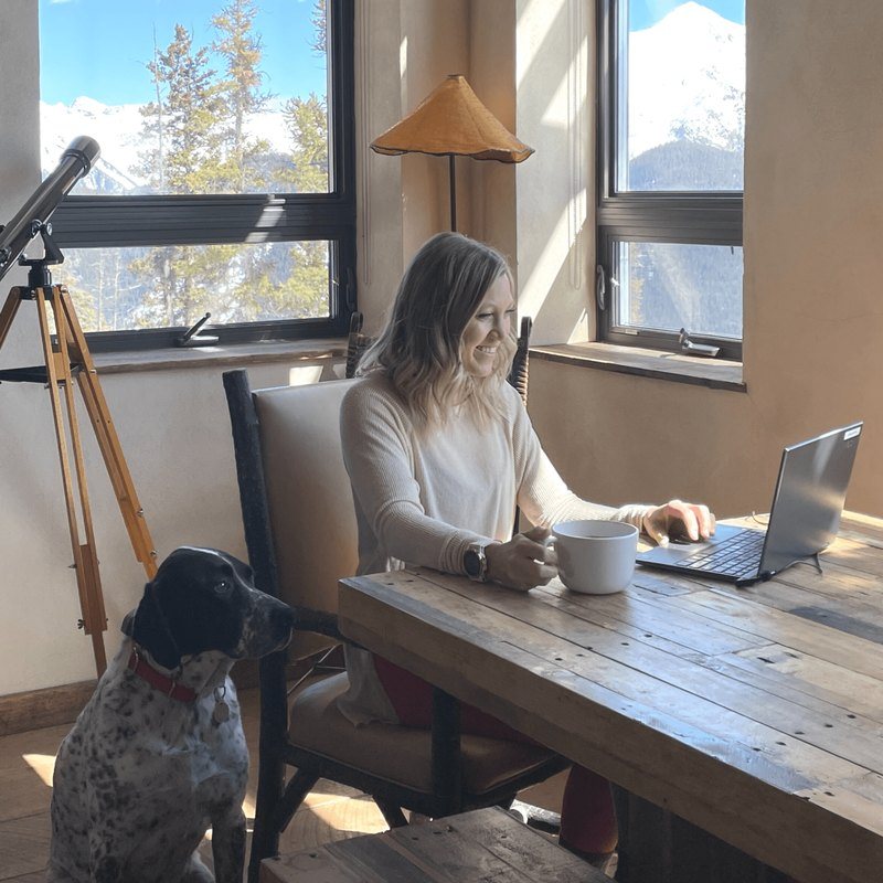 A therapist running a telehealth session from her laptop